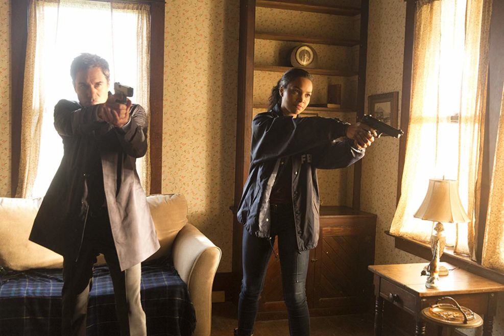 Characters on the show Travelers with their guns drawn